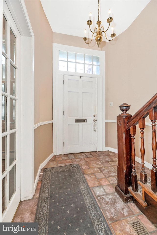 entrance foyer with a chandelier