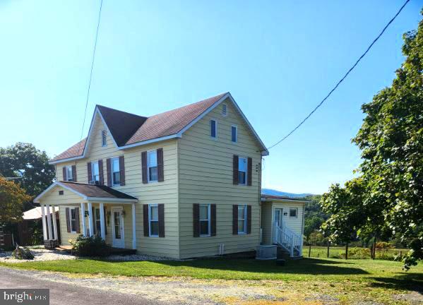 view of property exterior with a lawn