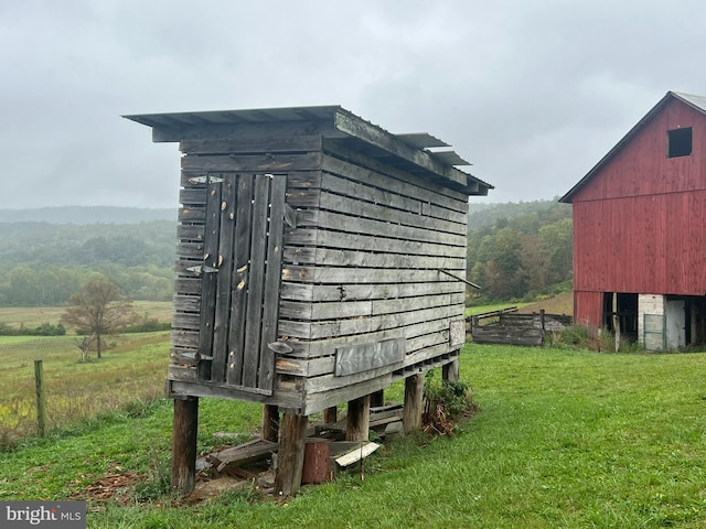 exterior space featuring a lawn and a rural view