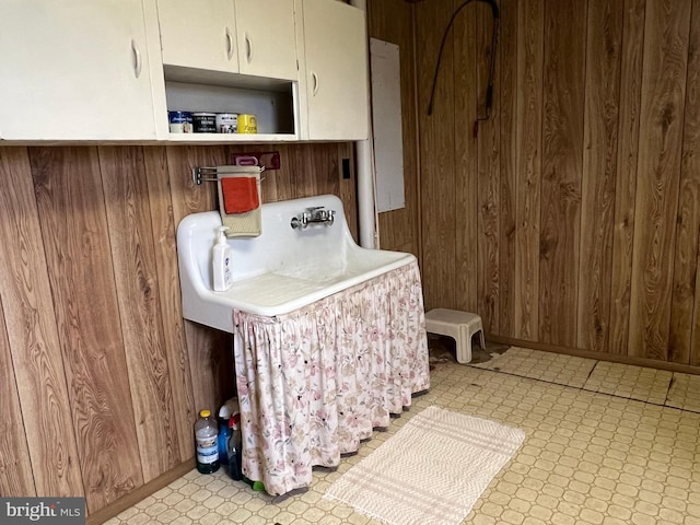 laundry area with wooden walls