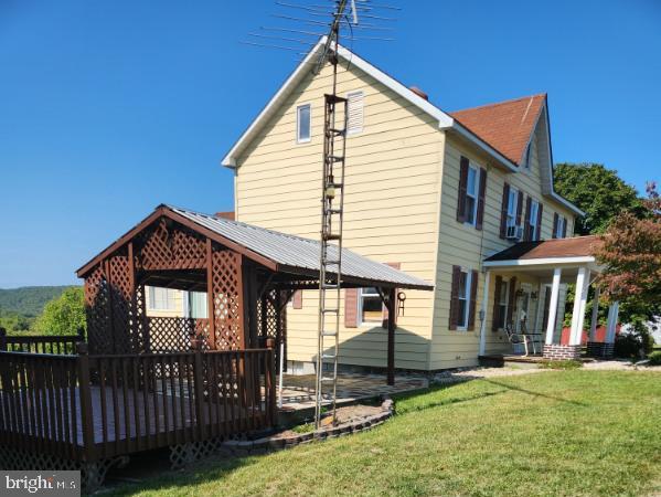 back of house with a lawn