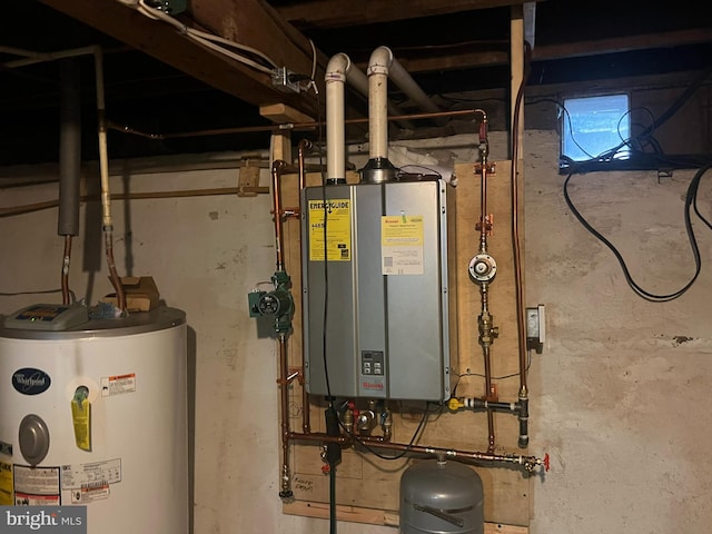 utility room with gas water heater and water heater