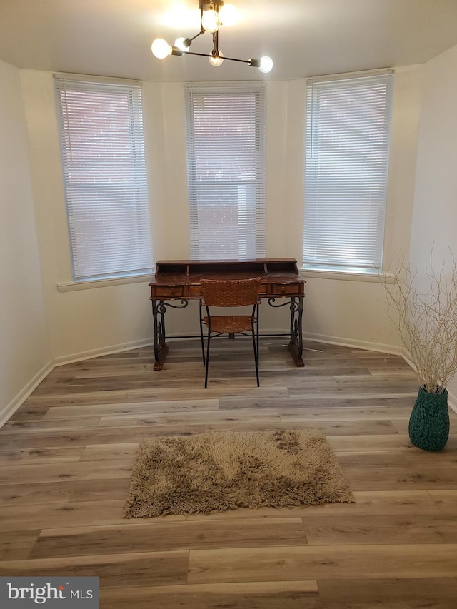 office space featuring a chandelier and hardwood / wood-style floors