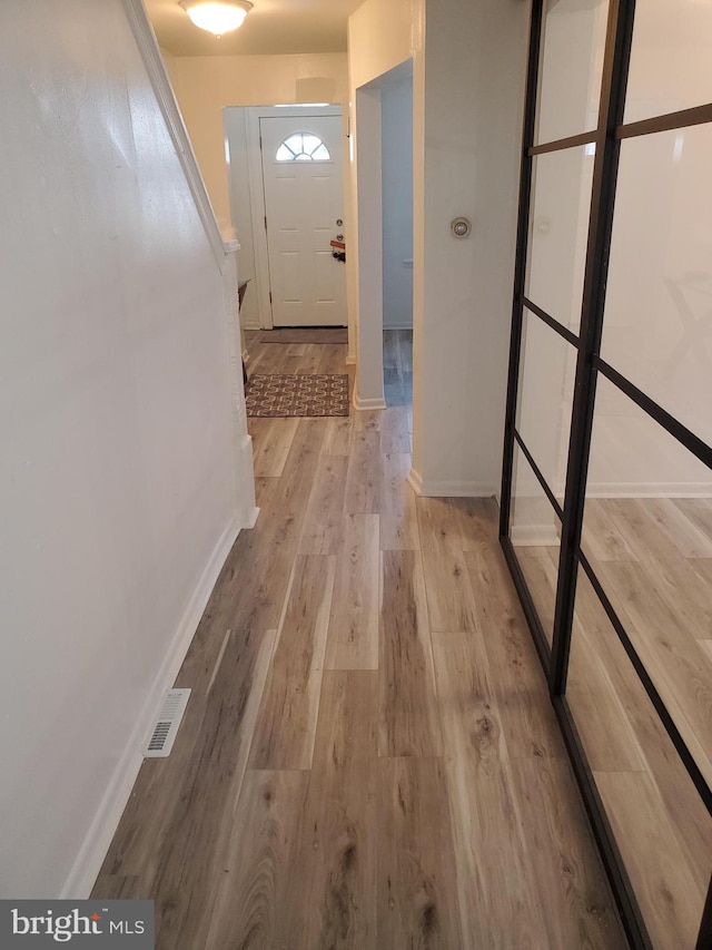 hallway with light hardwood / wood-style flooring