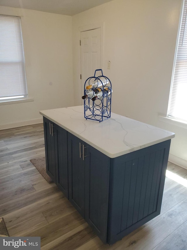 kitchen featuring light stone counters and light hardwood / wood-style floors