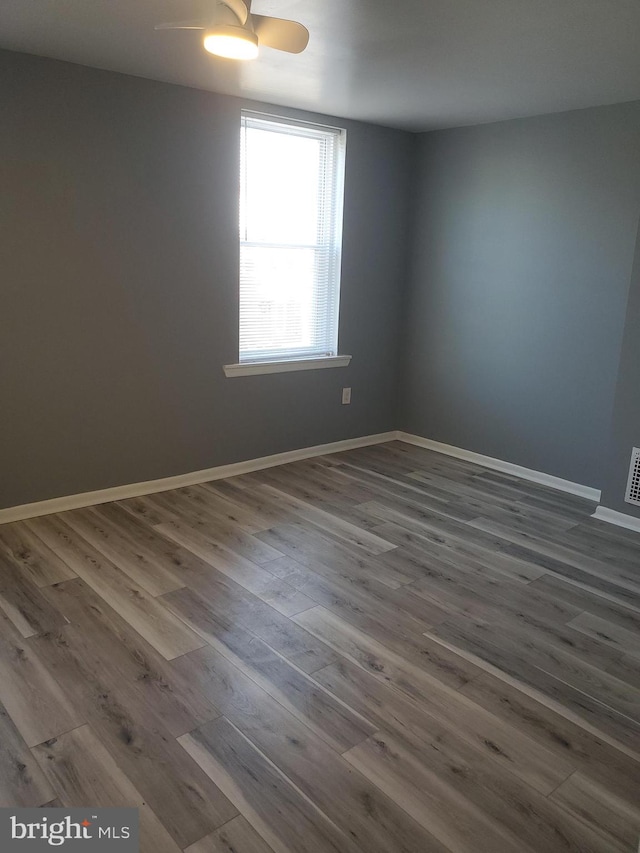 spare room with wood-type flooring and ceiling fan