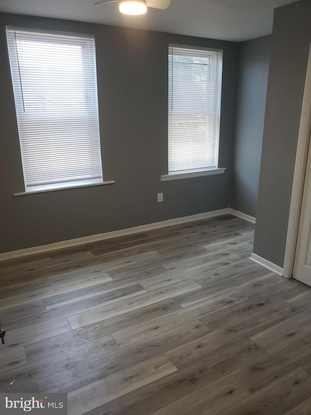 empty room with light wood-type flooring and ceiling fan