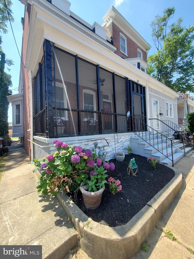 view of side of property featuring a sunroom