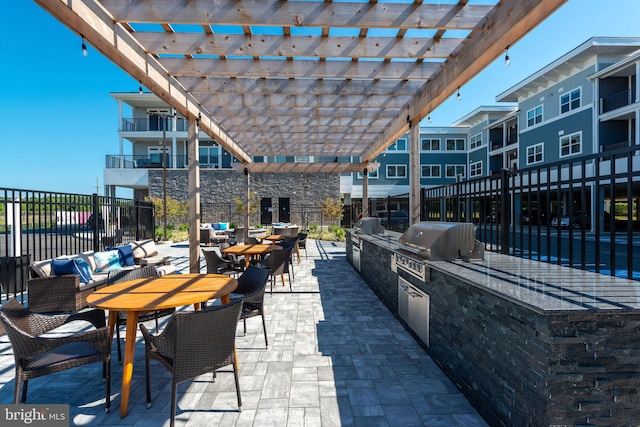 view of patio / terrace with area for grilling, outdoor lounge area, grilling area, a balcony, and a pergola