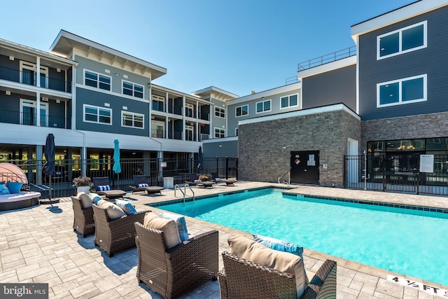 view of swimming pool with a patio and an outdoor hangout area