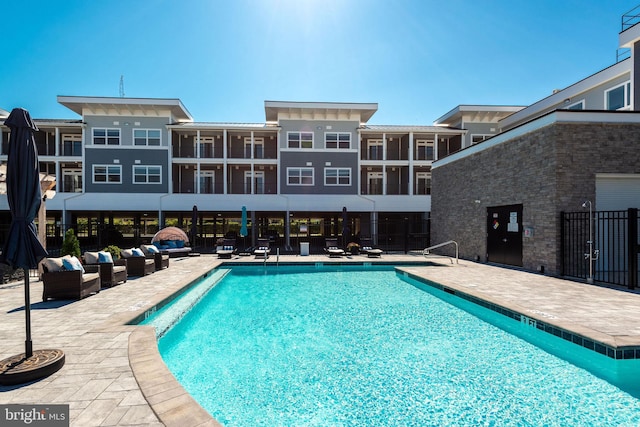 view of swimming pool featuring an outdoor living space and a patio area