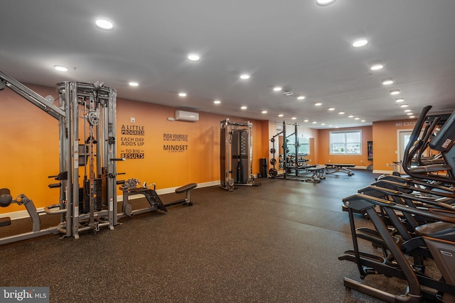 workout area featuring a wall mounted air conditioner