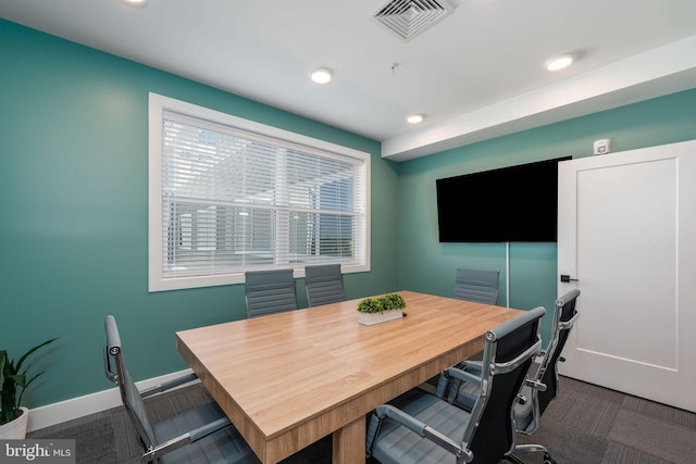 dining area featuring dark colored carpet