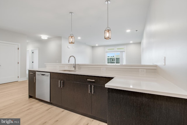 kitchen with light hardwood / wood-style floors, dishwasher, pendant lighting, dark brown cabinets, and sink