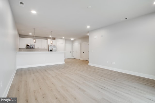 unfurnished living room featuring light wood-type flooring