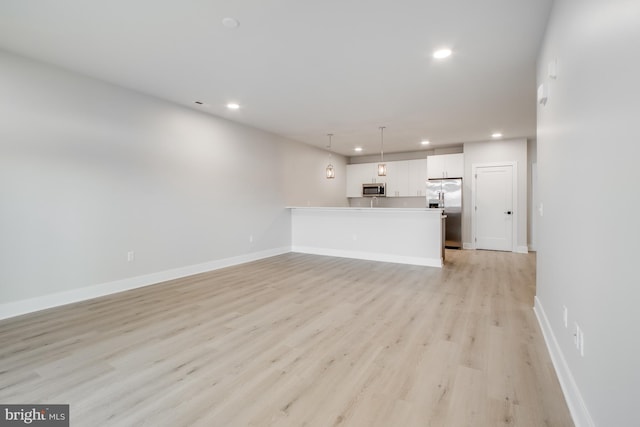 unfurnished living room featuring light hardwood / wood-style flooring