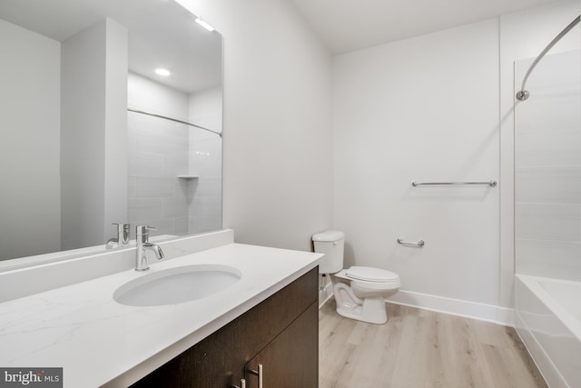 full bathroom with vanity, hardwood / wood-style floors, toilet, and bathing tub / shower combination