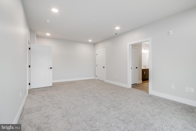 unfurnished room with light carpet