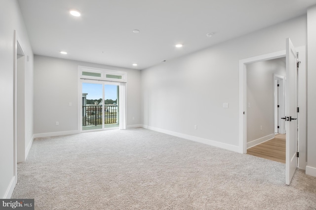 spare room featuring light colored carpet