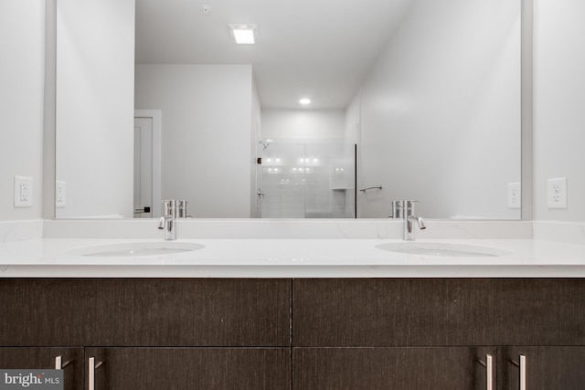 bathroom featuring vanity and a shower with shower door