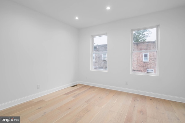 spare room with light hardwood / wood-style flooring