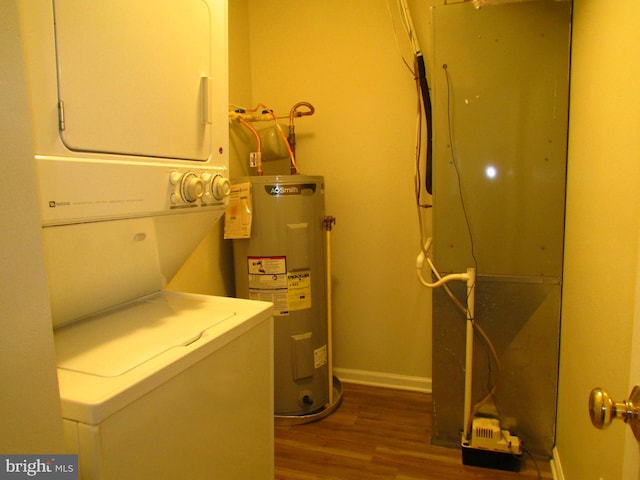 clothes washing area featuring electric water heater, wood-type flooring, and stacked washer / drying machine