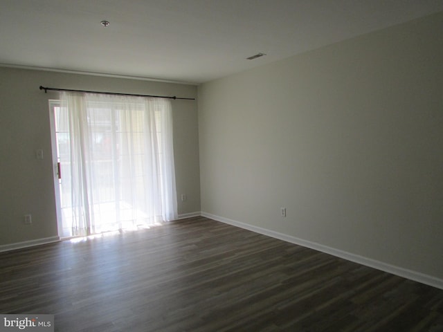 unfurnished room with dark hardwood / wood-style floors