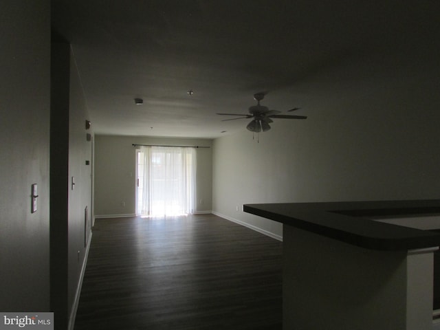 spare room featuring dark hardwood / wood-style floors and ceiling fan