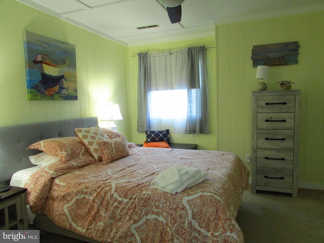 carpeted bedroom with ceiling fan and ornamental molding