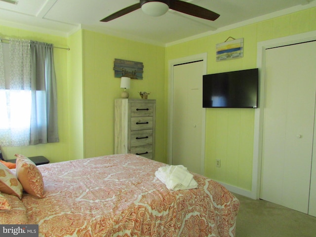 carpeted bedroom featuring ornamental molding and ceiling fan