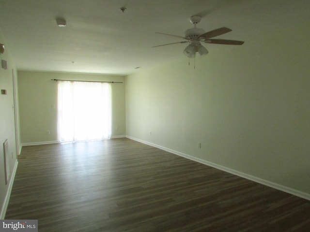 empty room with ceiling fan and dark hardwood / wood-style floors