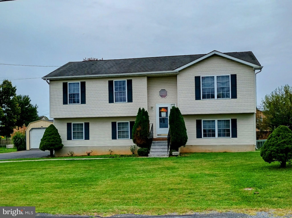 bi-level home featuring a garage and a front lawn