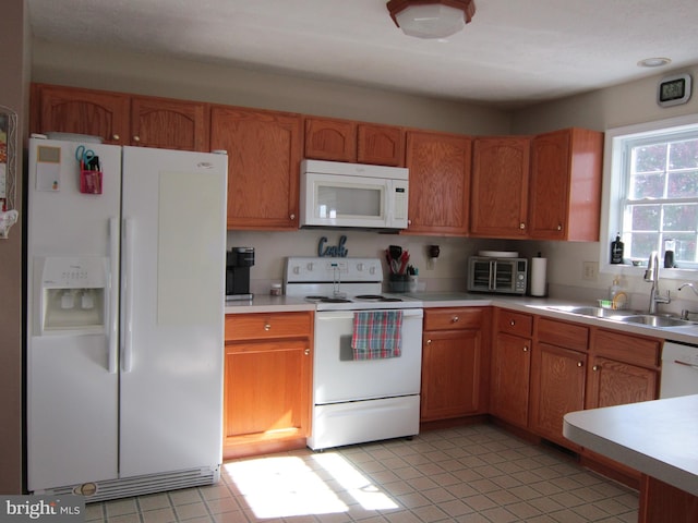 kitchen featuring white appliances and sink