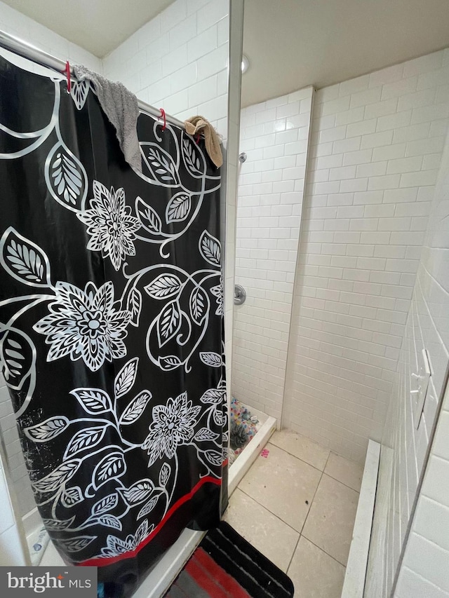 bathroom featuring a shower with shower curtain and tile patterned flooring