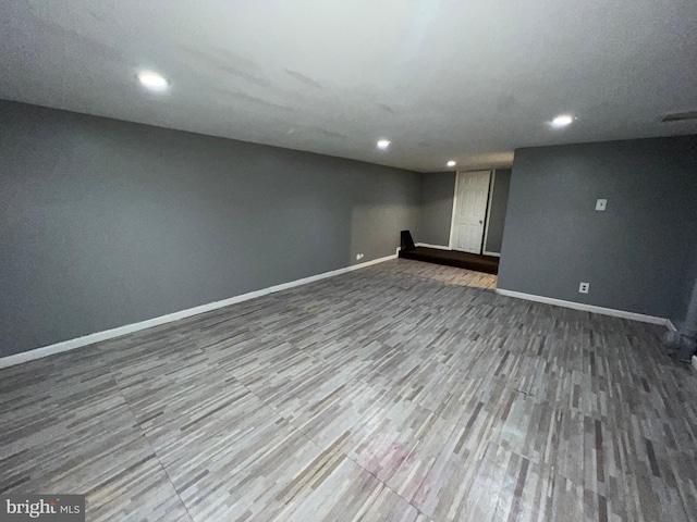 basement with hardwood / wood-style flooring