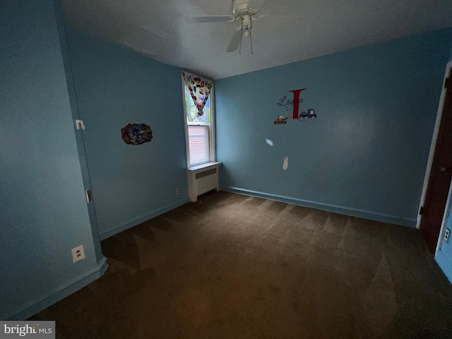 unfurnished bedroom with ceiling fan, carpet flooring, and radiator heating unit