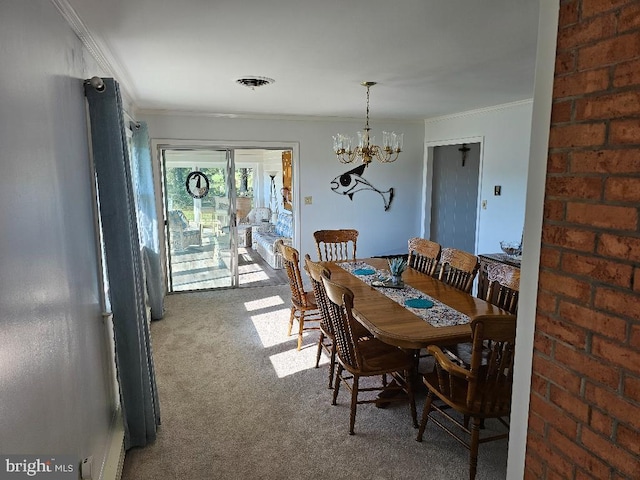 dining space with ornamental molding, carpet, and an inviting chandelier