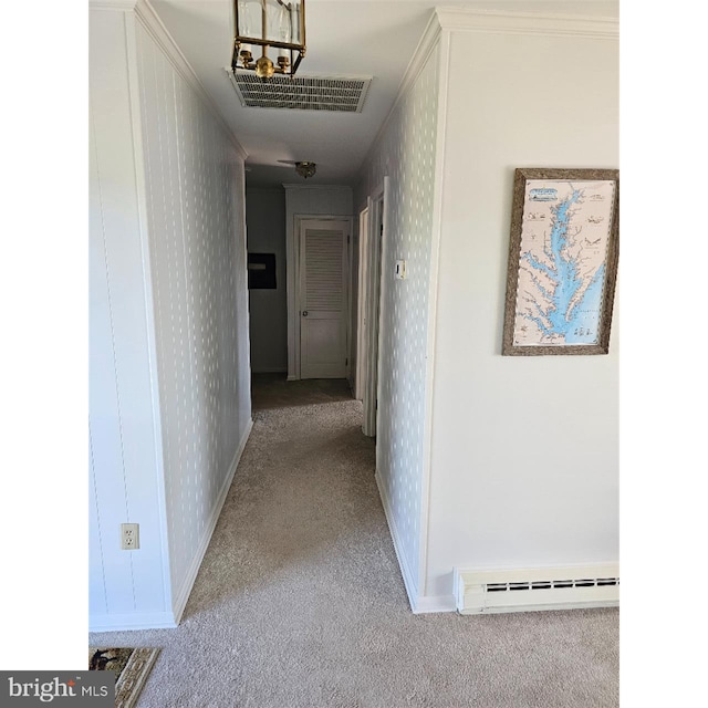 hall with crown molding, baseboard heating, and light colored carpet