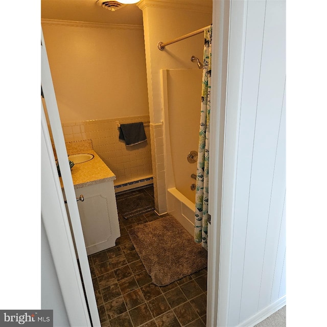 bathroom featuring tile walls, tile patterned flooring, a baseboard radiator, shower / bath combo with shower curtain, and vanity