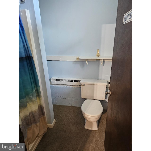 bathroom with walk in shower, toilet, and a baseboard heating unit