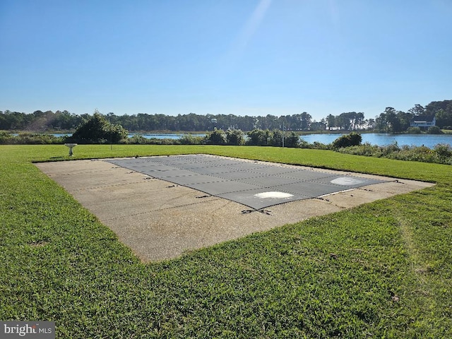 exterior space featuring a lawn and a water view