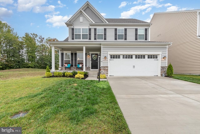 view of front of home featuring covered porch, a front yard, and a garage