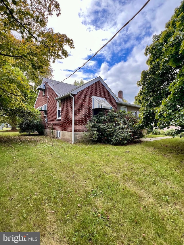 view of home's exterior with a yard