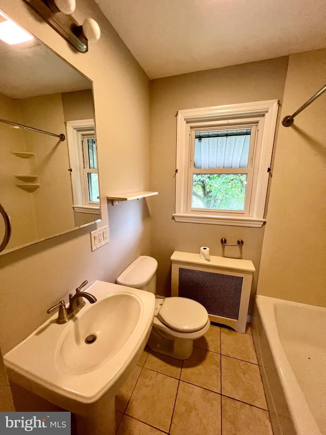 full bathroom with radiator, toilet, sink, shower / washtub combination, and tile patterned flooring