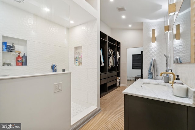 bathroom with vanity and a shower