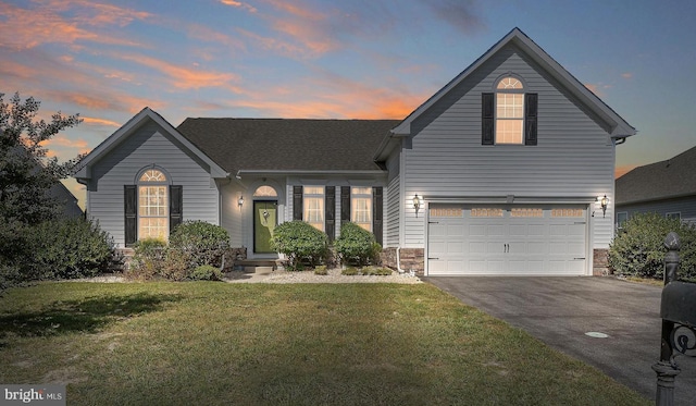 view of front property with a lawn and a garage