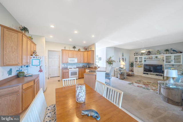 carpeted dining area with sink