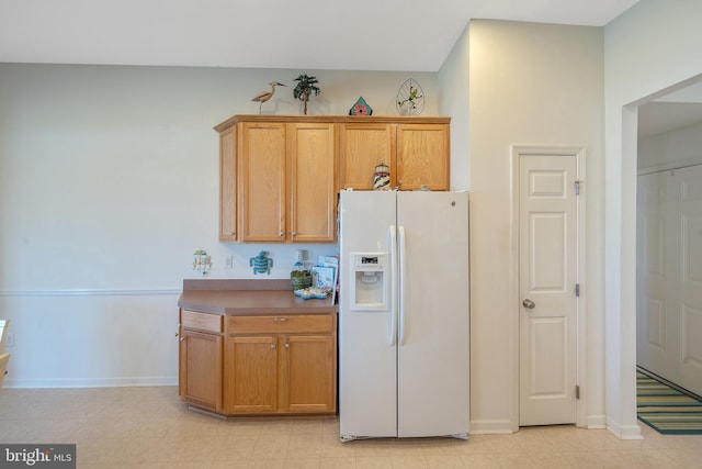 kitchen with white fridge with ice dispenser