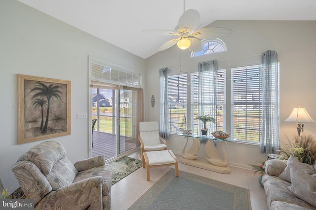 sitting room featuring lofted ceiling, light tile patterned floors, and ceiling fan