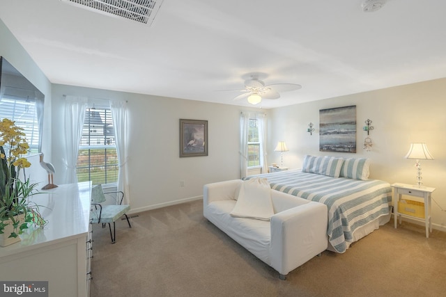 carpeted bedroom with multiple windows and ceiling fan